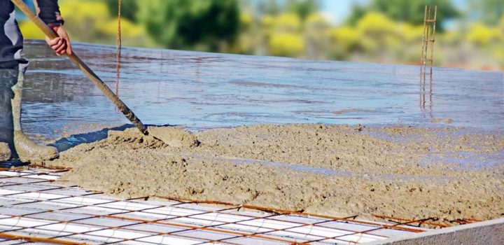 concrete broomed to level the material on the frames of an ongoing construction