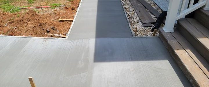 concrete sidewalk on the front yard of a house