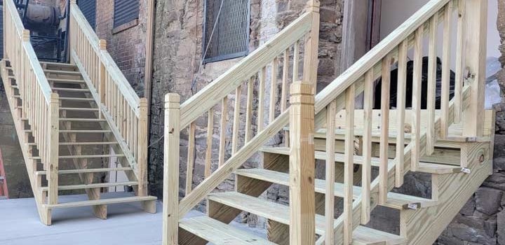 wood steps installed on a house with walls made of stone